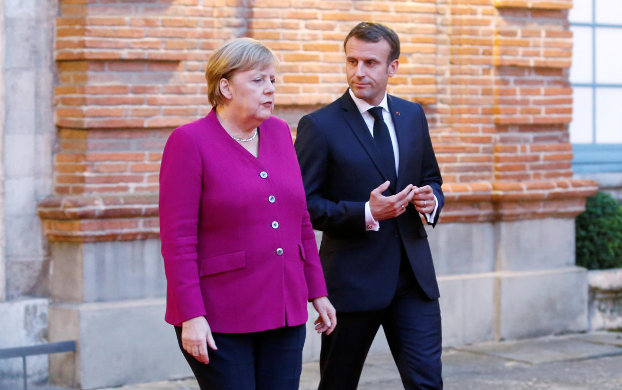 French President Emmanuel Macron and German Chancellor Angela Merkel welcome European Commission president-elect Ursula Von der Leyen (not pictured) after a joint Franco-German cabinet meeting in Toulouse, France, October 16, 2019. REUTERS/Regis Duvignau