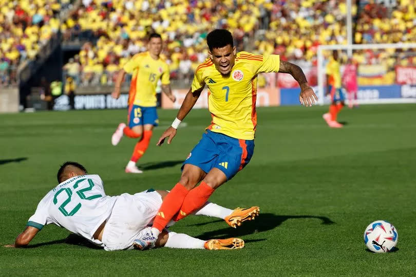 Luis Diaz #7 of Colombia is tripped by Hector Cuellar #22 of Bolivia during the second half of their international friendly match at Pratt & Whitney Stadium on June 15, 2024 in Hartford, Connecticut.