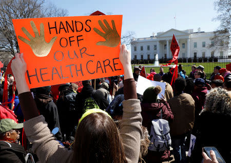 Protesters demonstrate against U.S. President Donald Trump and his plans to end Obamacare outside the White House in Washington, U.S., March 23, 2017. REUTERS/Kevin Lamarque