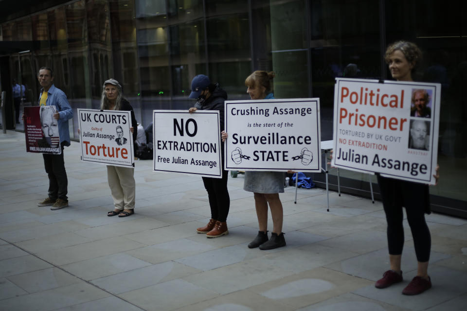 Supporters of WikiLeaks founder Julian Assange take part in a protest outside the Central Criminal Court, the Old Bailey, in London, Monday, Sept. 14, 2020. The London court hearing on Assange's extradition from Britain to the United States resumed Monday after a COVID-19 test on one of the participating lawyers came back negative, WikiLeaks said Friday. (AP Photo/Matt Dunham)