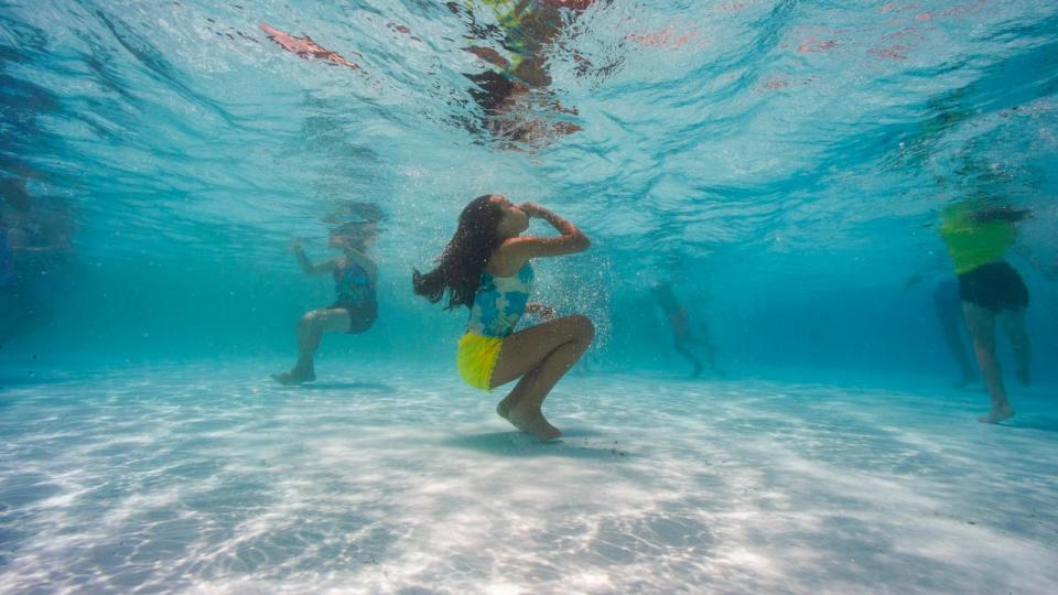 PHOTO: A child ducks underwater to cool off at the Vietnam Veterans Memorial Pool in Chelsea, MA, June 24, 2024.  (Joseph Prezioso/AFP via Getty Images)