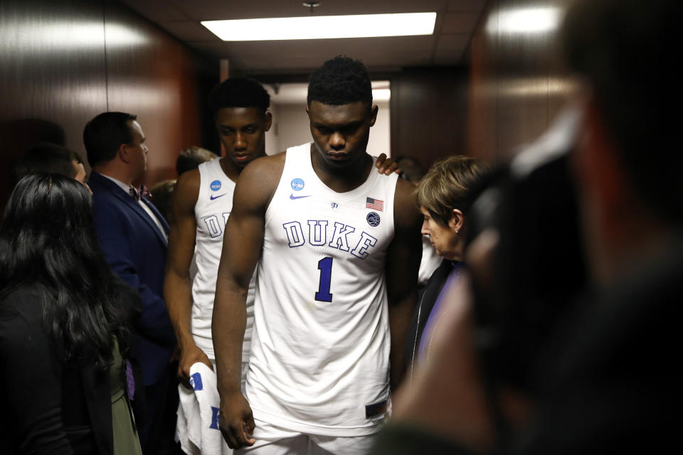 Duke forward Zion Williamson (1) walks out of the Duke locker room with teammate Tre Jones after a loss to Michigan State. (AP)