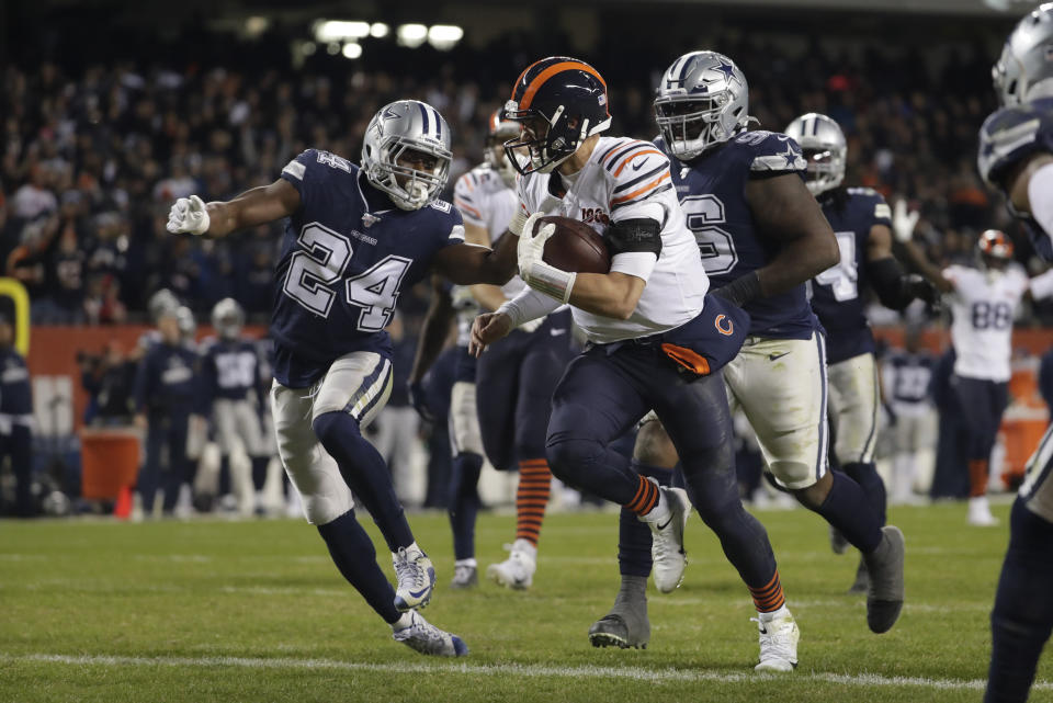 Chicago Bears quarterback Mitchell Trubisky (10) runs in for a touchdown against Dallas Cowboys' Chidobe Awuzie (24) during the second half of an NFL football game, Thursday, Dec. 5, 2019, in Chicago. (AP Photo/Morry Gash)