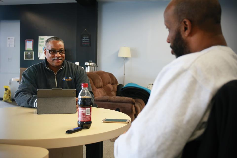 Eric Webster, a recovery coach at the Blue Water Recovery and Outreach Center, talks to Carlo Anderson, a person in recovery, on Wednesday, Feb. 9, 2022, during a session at the center in Port Huron.