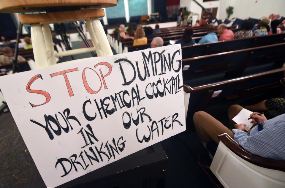 A sign written by Rebekah Cain Saenz sits on a chair during a Chemours community information session in St. Pauls, N.C., June 12, 2018. Saenz grew up less than 2 miles from the Fayetteville Works plant. STARNEWS FILE PHOTO