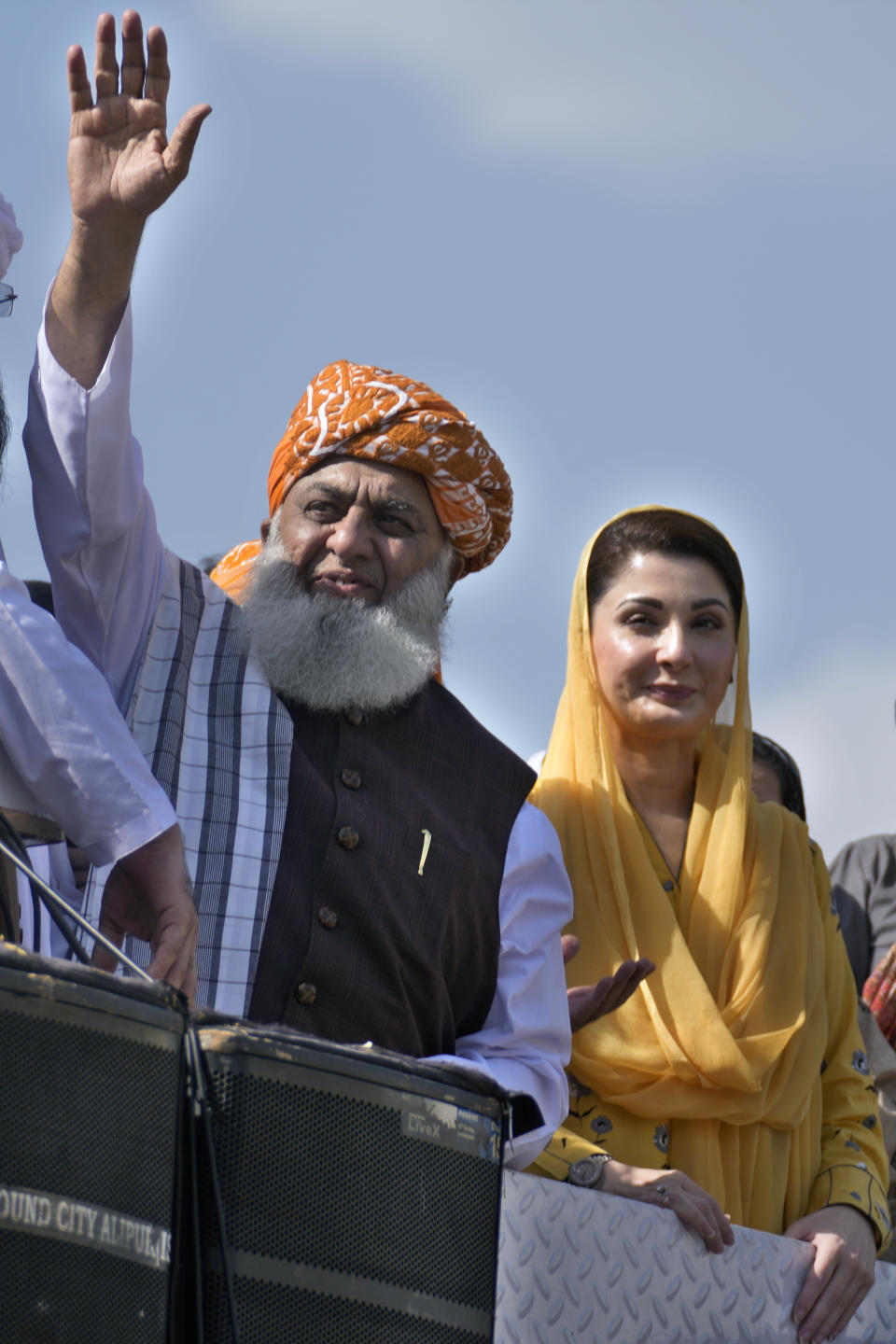 Maulana Fazalur Rehman, left, and Maryam Nawaz, right, leaders of Pakistan Democratic Alliance, wave to supporters during a protest outside the Supreme Court, in Islamabad, Pakistan, Monday, May 15, 2023. Thousands of Pakistani government supporters converged on the country's Supreme Court, in a rare challenge to the nation's judiciary. Protesters demanded the resignation of the chief justice over ordering the release of former Prime Minister Imran Khan. (AP Photo/Anjum Naveed)