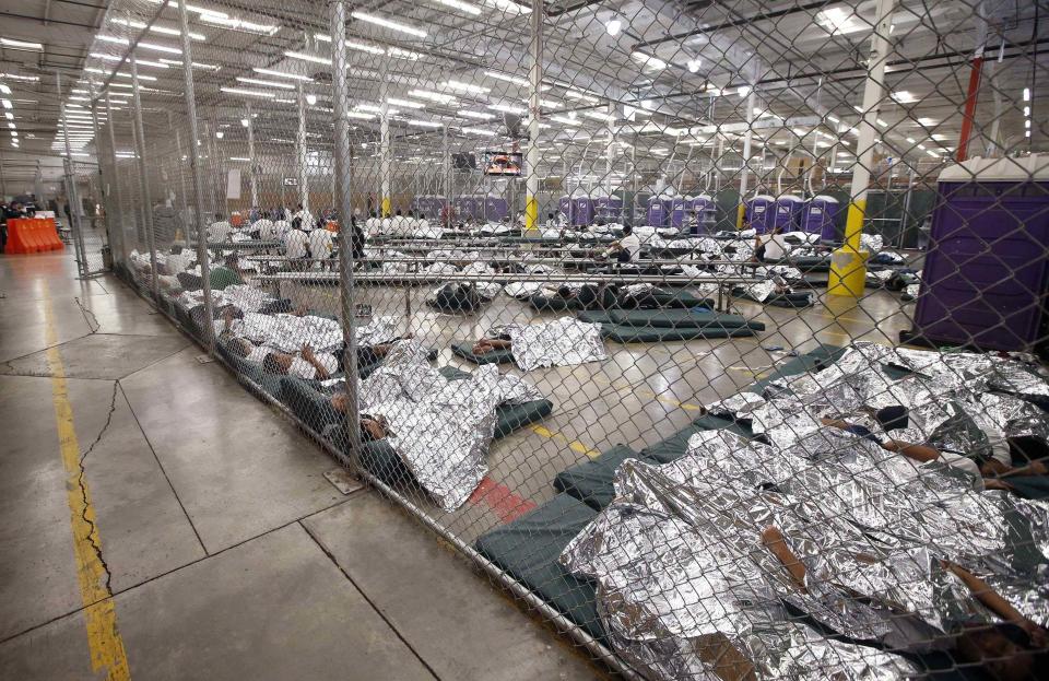 Detainees sleep and watch television in a holding cell where hundreds of mostly Central American immigrant children are being processed and held at the U.S. Customs and Border Protection (CBP) Nogales Placement Center in Nogales, Arizona, June 18, 2014. CBP provided media tours Wednesday of two locations in Brownsville, Texas, and Nogales, that have been central to processing the more than 47,000 unaccompanied children who have entered the country illegally since October 1, 2013. (REUTERS/Ross D. Franklin/Pool)