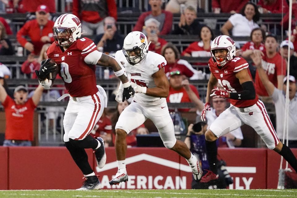 Wisconsin's Braelon Allen (0) gets past Illinois State's Dillon Gearhart (16) for a 96-yard touchdown run during the first half of an NCAA college football game Saturday, Sept. 3, 2022, in Madison, Wis. (AP Photo/Morry Gash)