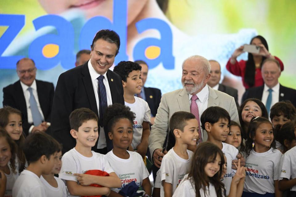 Brazilian President Luiz Inacio Lula da Silva (in tan suit) and Minister of Education Camilo Santana attend the launch of the literacy program for schoolchildren. <a href="https://www.gettyimages.com/detail/news-photo/brazilian-president-luiz-inacio-lula-da-silva-and-minister-news-photo/1258642461?adppopup=true" rel="nofollow noopener" target="_blank" data-ylk="slk:Mateus Bonomi/Anadolu Agency via Getty Images;elm:context_link;itc:0;sec:content-canvas" class="link ">Mateus Bonomi/Anadolu Agency via Getty Images</a>