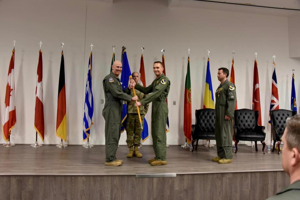 Maj. Gen. Clark J. Quinn, far left, commander of the 19th Air Force at Joint Base San Antonio-Randolph, hands off the 80th Flying Training Wing flag to Col. Mitchell J. Cok during a change of command ceremony March 7 at Sheppard Air Force Base as Cok assumes command of the 80th FTW.