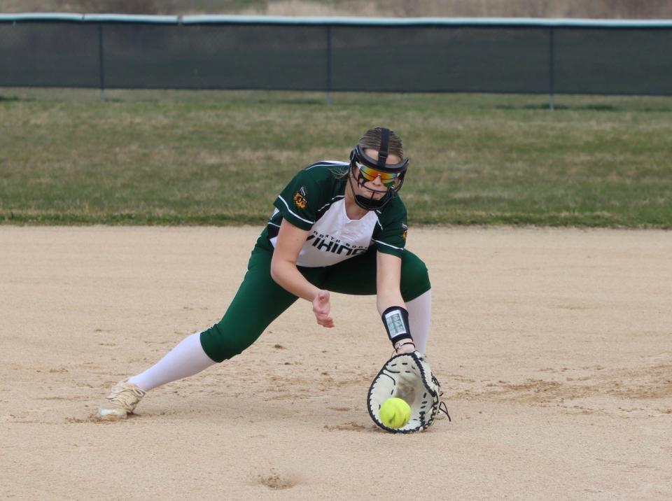 Marlee Alderman, a freshman standout for the North Boone softball team, goes down to scoop up a grounder during a recent Vikings' game this season.