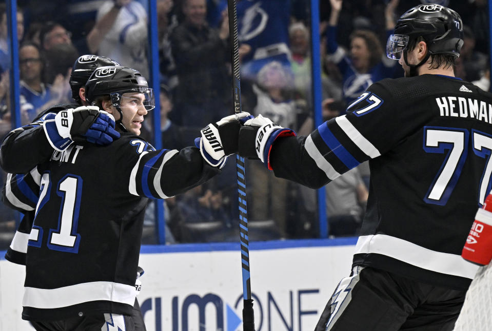 Tampa Bay Lightning center Brayden Point (21) and defenseman Victor Hedman (77) celebrate Point's goal during the second period of an NHL hockey game against the Montreal Canadiens, Saturday, March 2, 2024, in Tampa, Fla. (AP Photo/Jason Behnken)