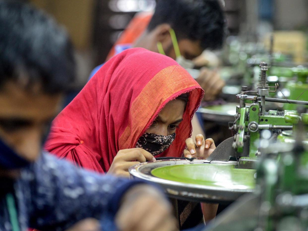 Factory workers make garments in Savar, Bangladesh on 18 June, 2020: AFP via Getty Images