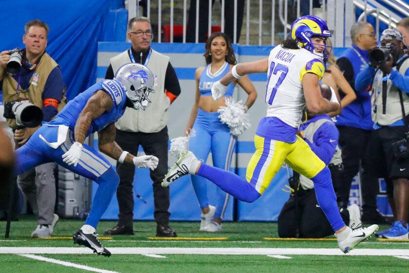 The Rams' Puka Nacua (17) runs to complete a 50-yard touchdown catch past the Lions' Cameron Sutton.