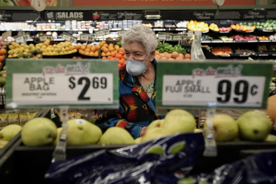 FILE - In this March 17, 2020 file photo, Carmen Zamora shops at Northgate González Market in Santa Ana, Calif., during an early-hour shopping time for those over 65 and the disabled. Taxpayers will pay restaurants to make three meals a day for California's millions of seniors during the coronavirus pandemic, Gov. Gavin Newsom announced Friday, April 24, 2020, putting the industry back to work and generating sales tax collections for cash-strapped local governments. California has about 5.7 million people 65 and older, but not all of them will be eligible. Newsom said seniors must have either been exposed to the virus, have a high risk for potential exposure or a compromised immune system. (AP Photo/Chris Carlson)