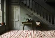 <p>Make a feature of your patterned carpet by choosing a bold mix of warm colours, and limiting the colour palette in the rest of your room to cooler shades. The deep green here is the perfect complement to the warmer reds and oranges in this Carpetright striped carpet. </p><p>Pictured: <a href="https://www.carpetright.co.uk/carpets/residence-striped-carpet/" rel="nofollow noopener" target="_blank" data-ylk="slk:Residence Striped Carpet at Carpetright;elm:context_link;itc:0;sec:content-canvas" class="link ">Residence Striped Carpet at Carpetright</a></p>