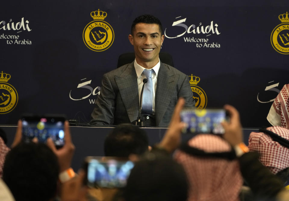 Cristiano Ronaldo smiles during a press conference for his official unveiling as a new member of Al Nassr soccer club in in Riyadh, Saudi Arabia, Tuesday, Jan. 3, 2023. Ronaldo, who has won five Ballon d'Ors awards for the best soccer player in the world and five Champions League titles, will play outside of Europe for the first time in his storied career. (AP Photo/Amr Nabil)