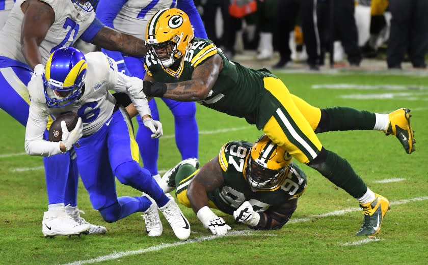 Rams quarterback Jared Goff is sacked by the Packers' Kenny Clark (97) and Rashan Gary (52) on Jan. 16, 2021.