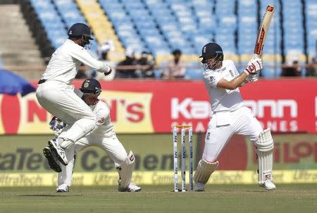 Cricket - India v England - First Test cricket match - Saurashtra Cricket Association Stadium, Rajkot - 9/11/16. England's Joe Root (R) plays a shot. REUTERS/Amit Dave