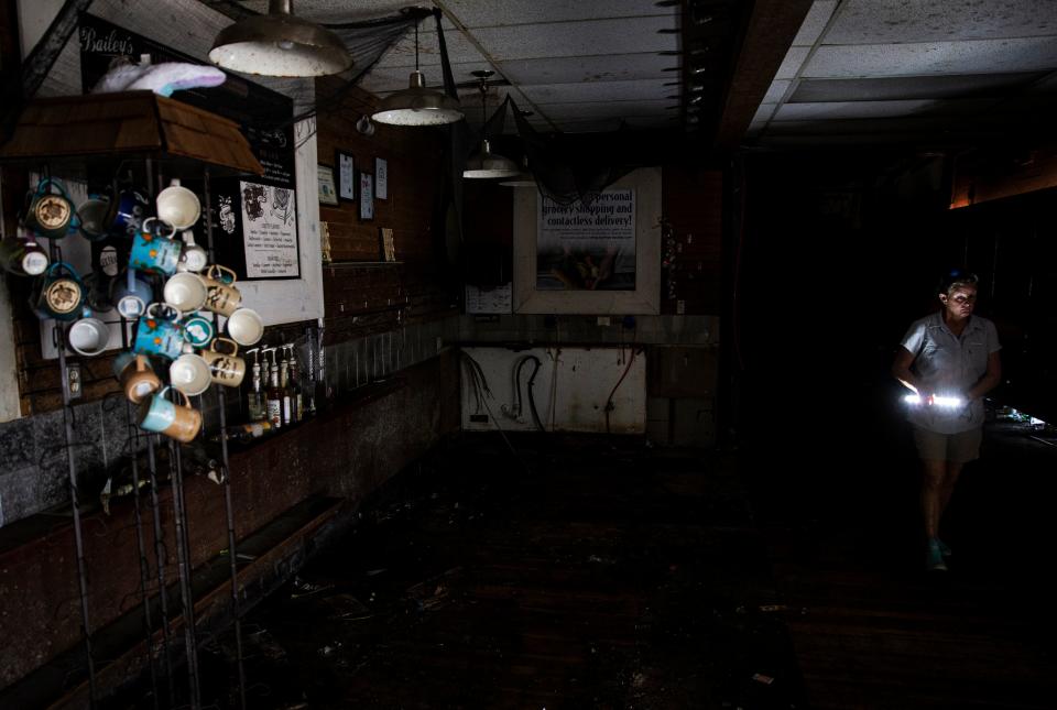 Mead Johnson, one of the owners of Bailey’s General Store on Sanibel looks at destroyed shelves on Wednesday, Jan. 4, 2023 after it was flooded by Hurricane Ian. The plan is to tear down the existing building and re-open in a rebuilt space that will be raised.  