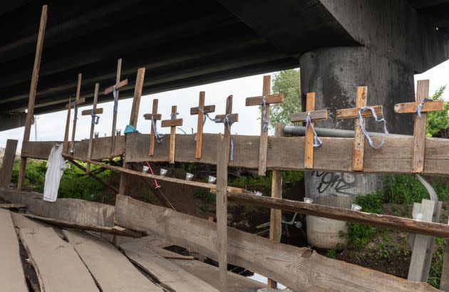Crosses attached to a destroyed bridge in the town of Irpin, in the Kyiv region of Ukraine, memorialize the 60 people killed in nearby Bucha by Russian forces. Whether Russia's actions in the invasion of Ukraine rise to the level of genocide, as defined in a 1948 global treaty, has come under debate. (Photo: SOPA Images via Getty Images)