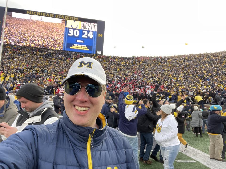 Zachary Garton, 31 of Kalamazoo, enjoys the University of Michigan's win against Ohio State in November. Garton travels to Ann Arbor for just about every Michigan football game, even away games, never without his white block M hat.