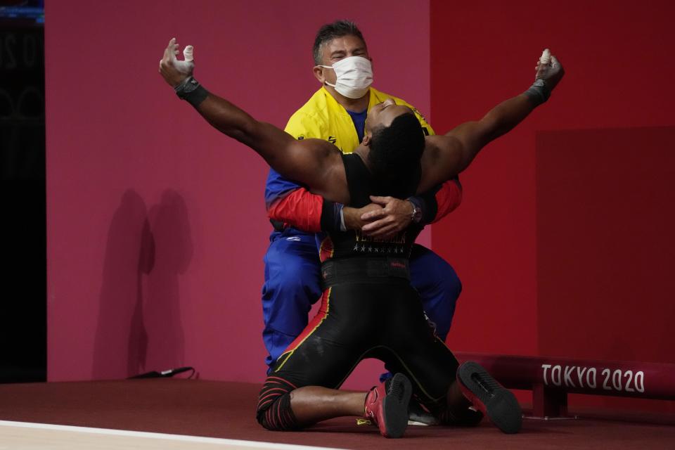 Julio Ruben Mayora Pernia of Venezuela celebrates after winning the silver medal in the men's 73kg weightlifting event, at the 2020 Summer Olympics, Wednesday, July 28, 2021, in Tokyo, Japan. (AP Photo/Luca Bruno)