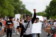 Protesters gather at the scene where Floyd was pinned down by a police officer in Minneapolis