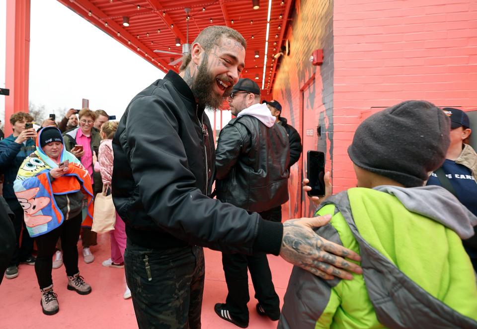 Post Malone greets fans before hosting the grand opening celebration of a Raising Cane’s Restaurant, designed by the singer, in Midvale on Thursday, April 13, 2023. | Kristin Murphy, Deseret News