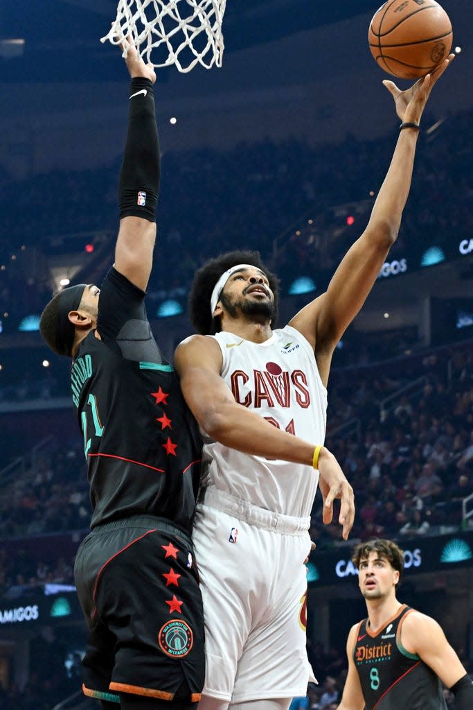 Cavaliers center Jarrett Allen shoots against Daniel Gafford of the Wizards during the first half, Friday, Jan. 5, 2024, in Cleveland.