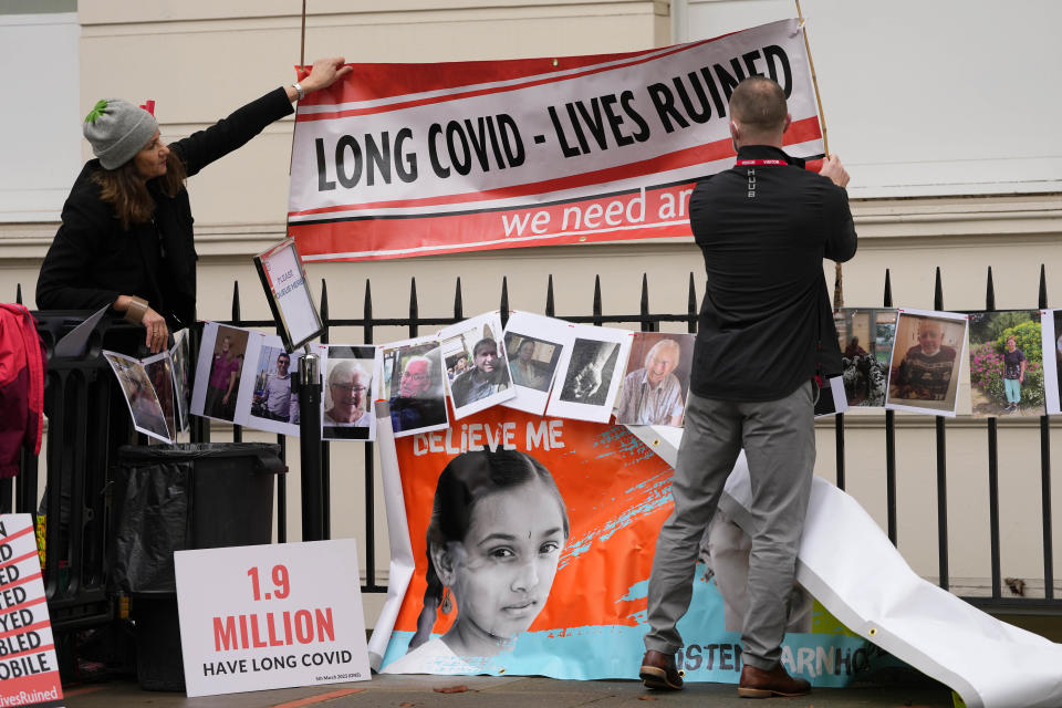 Protesters fix a banner outside Dorland House as Britain's former Prime Minister Boris Johnson testifies at Britain's COVID-19 public inquiry in London, Thursday, Dec. 7, 2023. (AP Photo/Kirsty Wigglesworth)