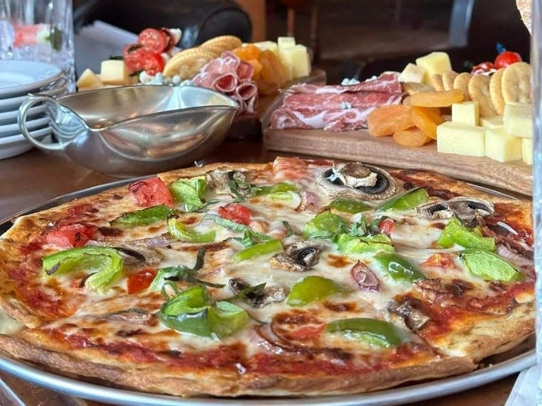 The menu at 21st Amendment in downtown Vero Beach features shareable items, such as pizzas, charcuterie boards and homemade pimento cheese dip.