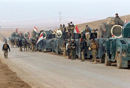 Military vehicles of Iraqi rapid response forces gather during a battle with Islamic State militants , eastern Mosul, Iraq, December 22, 2016. REUTERS/Khalid al Mousily/Files