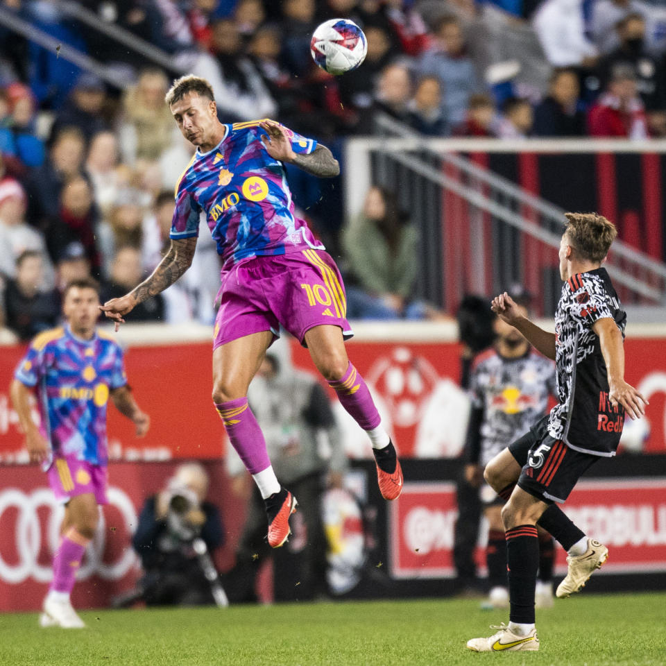 Toronto FC forward Federico Bernardeschi, front left, jumps for the ball against New York Red Bulls midfielder Daniel Edelman, right, during an MLS soccer match Saturday, Oct. 7, 2023, in Harrison, N.J. (AP Photo/Eduardo Munoz Alvarez)