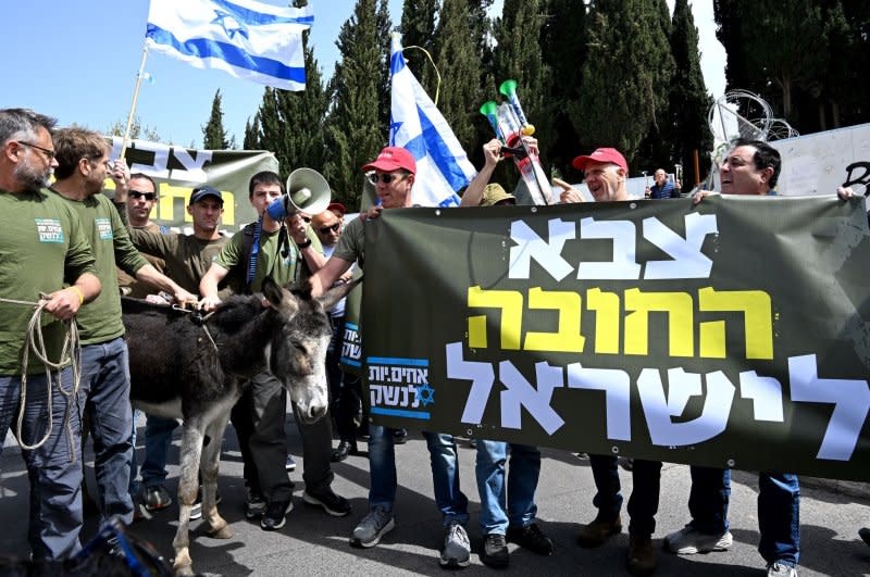 Israeli army reserve activists from Brothers In Arms stand with a donkey at a protest against military exemption for the Orthodox, or Haredim, citizens outside Prime Minister Benjamin Netanyahu's office in Jerusalem on Tuesday. Photo by Debbie Hill/UPI