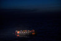 Migrants sit in a life raft off the waters of Tunisia early Wednesday, May 25, 2022. Some 110 people were rescued by the non-governmental organization Open Arms during a mission in the Mediterranean Sea after their boat capsized. (AP Photo/Valeria Ferraro)