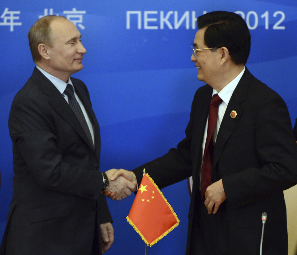 Russian President Vladimir Putin, left, shakes hands with Chinese President Hu Jintao during a signing ceremony at the Shanghai Cooperation Organization (SCO) summit at the Great Hall of the People in Beijing, China Thursday, June 7, 2012. (AP Photo/Mark Ralston, Pool)
