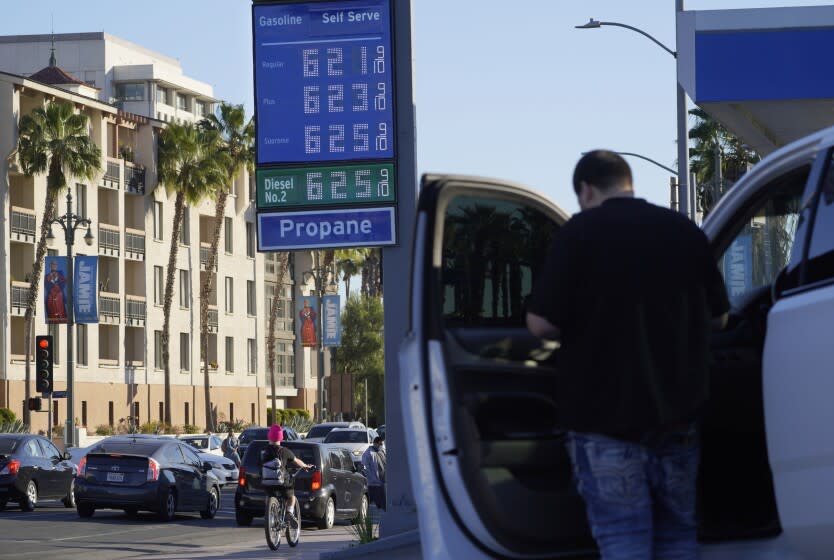 A motorist pauses at a gas station displaying higher gasoline prices at a Chevron station downtown Los Angeles Friday, Feb. 18, 2022. Gas prices are up nearly 40% from a year ago and more than 6% over the past month, according to AAA. Suspending the federal tax of 18.4 cents a gallon would not offset the price increases that occurred recently as Russia threated Ukraine. And there is no guarantee that energy companies would pass all of the savings on to consumers. (AP Photo/Damian Dovarganes)