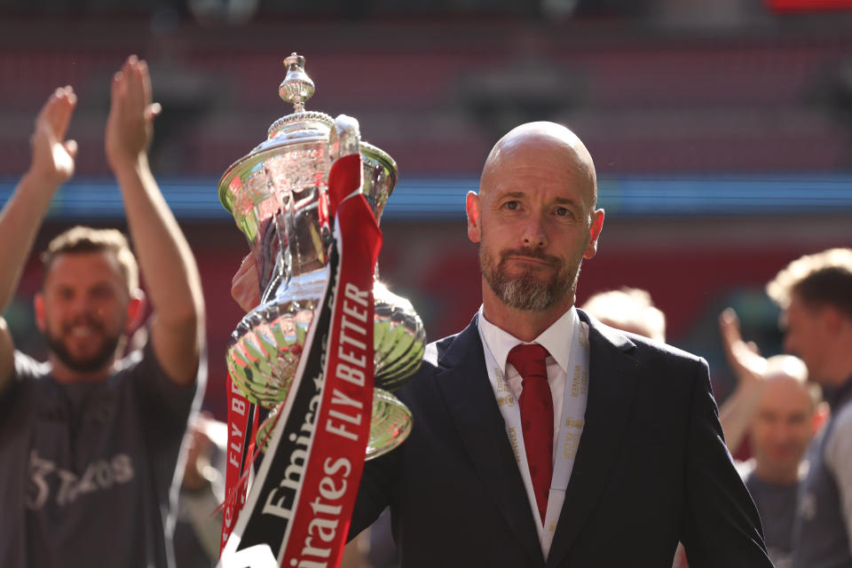 Manchester United's head coach Erik ten Hag celebrates with the trophy after winning the English FA Cup final soccer match between Manchester City and Manchester United at Wembley Stadium in London, Saturday, May 25, 2024. (AP Photo/Ian Walton)