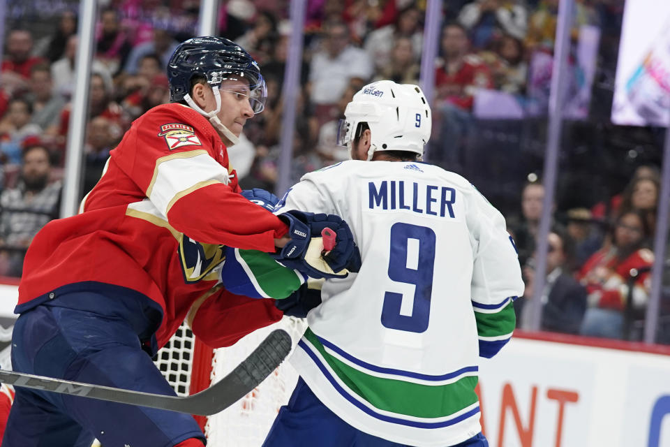 Florida Panthers defenseman Niko Mikkola, left, and Vancouver Canucks center J.T. Miller (9) scuffle during the first period of an NHL hockey game, Saturday, Oct. 21, 2023, in Sunrise, Fla. (AP Photo/Wilfredo Lee)