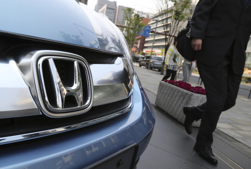 A man walks past a Honda model on display at Honda Motor Co. headquarters in Tokyo, Friday, April 25, 2014. Honda's profit for the fiscal fourth quarter zoomed to more than double the previous year's as the benefits of a weak yen added to strong sales. (AP Photo/Koji Sasahara)