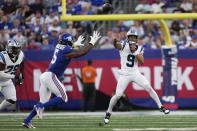 Carolina Panthers quarterback Bryce Young, right, throws past New York Giants' Kayvon Thibodeaux during the first half of an NFL preseason football game, Friday, Aug. 18, 2023, in East Rutherford, N.J. (AP Photo/Bryan Woolston)