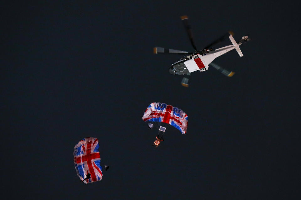 LONDON, ENGLAND - JULY 27:  Gary Connery and Mark Sutton parachute into the stadium as part of short James Bond film featuring Daniel Craig and The Queen during the Opening Ceremony of the London 2012 Olympic Games at the Olympic Stadium on July 27, 2012 in London, England.  (Photo by Cameron Spencer/Getty Images)