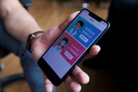 Li Libo, CEO of Lanchuang Network Technology Corp, displays the call center service of his company's intelligent elderly care system on an elderly smartphone prototype, during an interview in Weifang