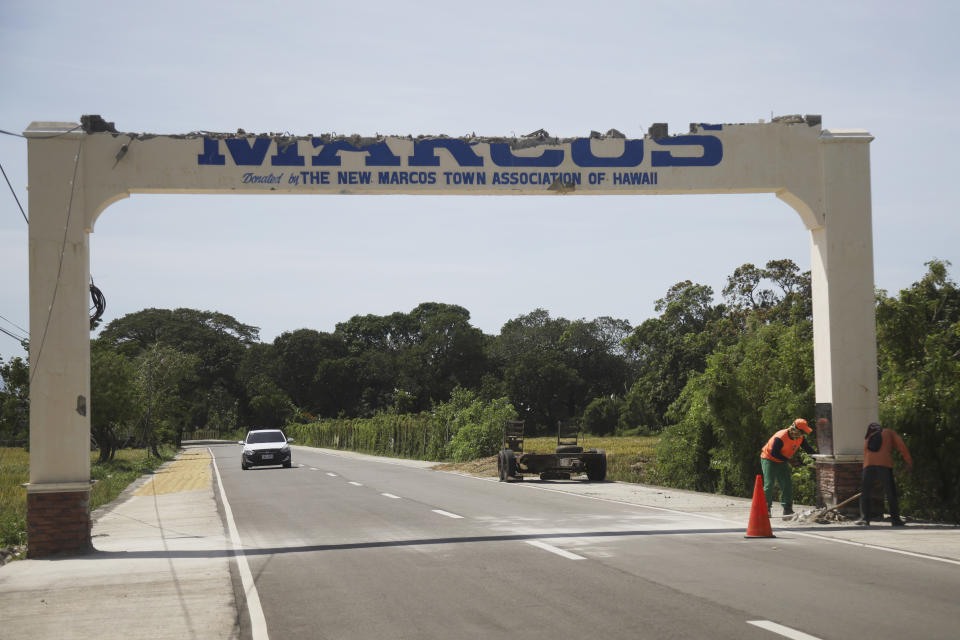 Workers clear debris from a sign that was damaged after a strong earthquake at Ilocos Norte, Northern Philippines on Wednesday Oct. 26, 2022. A strong earthquake rocked a large swathe of the northern Philippines, injuring multiple people and forcing the closure of an international airport and the evacuation of patients in a hospital, officials said Wednesday. (AP Photo)