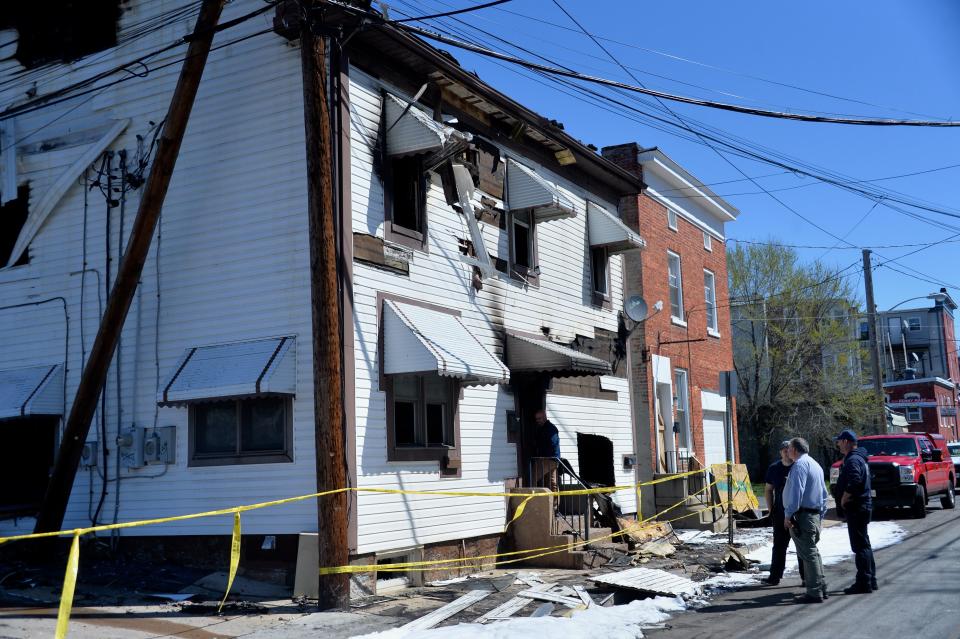 Fire officials, including Hagerstown Fire Marshal Dale Fishack in the blue shirt, check out the building at 24-28 W. Baltimore St., where there was a fire Sunday night.