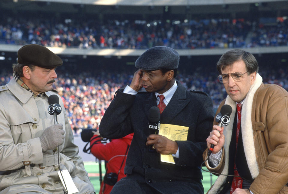 CBS NFL Today Show analyst Dick Butkus (L), Irv Cross (C) and commentator Brent Musburger (R) on the air prior to the start of an NFL Football game circa 1989. / Credit: Focus On Sport / Getty Images