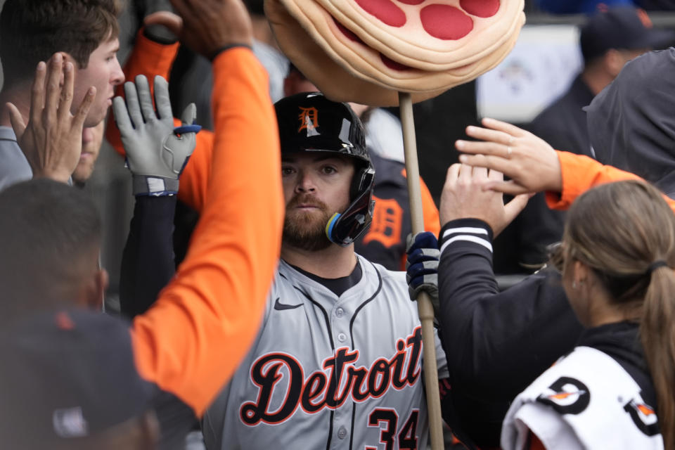 Detroit Tigers' Jake Rogers celebrates with teammates after hitting a solo home run during the fifth inning of a baseball game against the Chicago White Sox in Chicago, Sunday, March 31, 2024. (AP Photo/Nam Y. Huh)