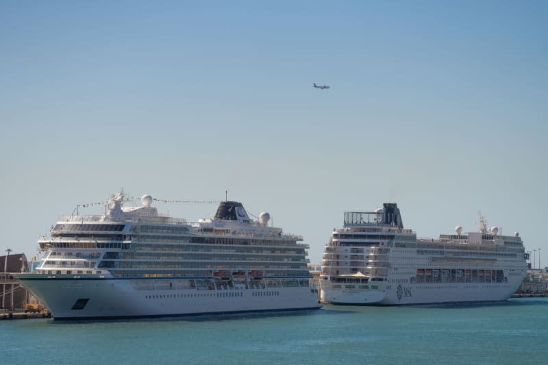 The MSC Armonia (R) is docked in the port of Barcelona.  The ship MSC Armonia is detained in the port of Barcelona because 69 Bolivian passengers do not have valid visas to enter the Schengen area.  David Zorakino/Europa Press/DPA