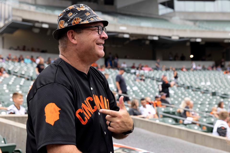 Jim Foster points to his jersey during the Bengals’ Back Together Saturday open practice, Saturday, July 31, 2021, at Paul Brown Stadium in the Downtown neighborhood of Cincinnati, Ohio.Foster, a life-long Bengals fan, has a Bengals YouTube channel, a podcast, a long-running tailgate and a Bengals history museum in his home. 